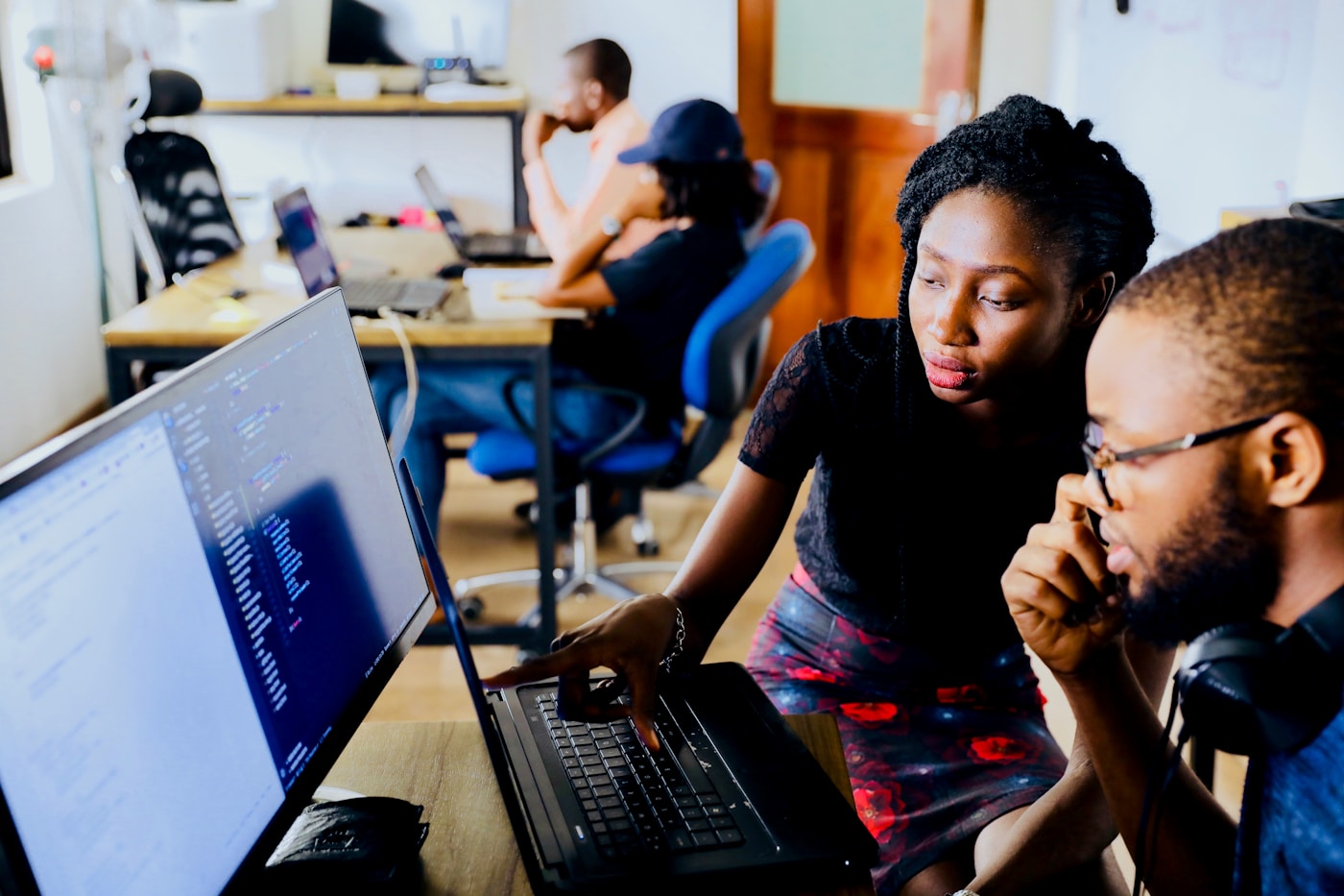 Two learners in paired AI practice during a profit sprint